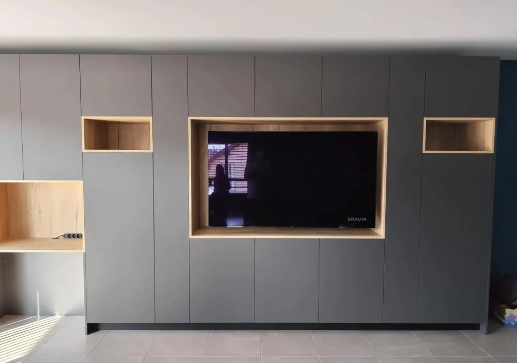 Meuble TV sur mesure réalisé par Vivet Agencement avec niches décoratives et rangements intégrés.